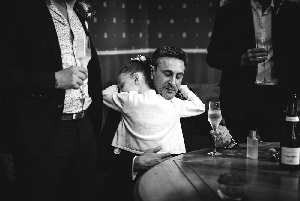Instant tendre entre marié et une petite fille lors de son mariage